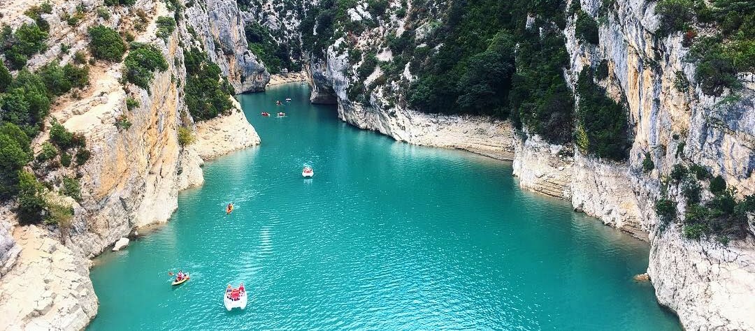 A body of water with boats in it and land around it. 