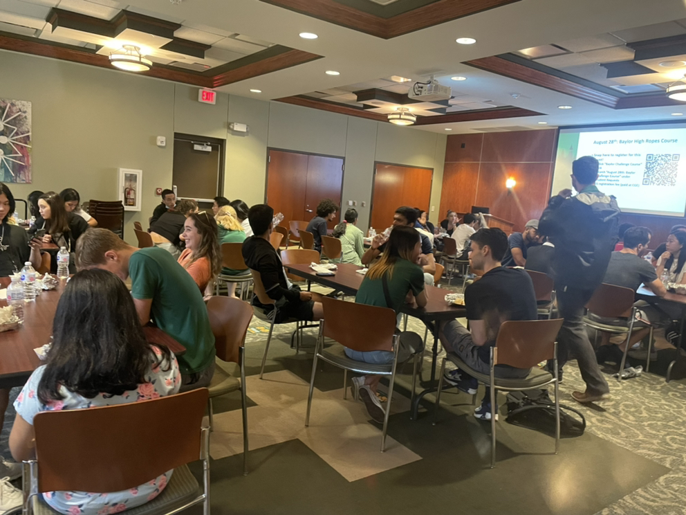 students at tables talking to each other