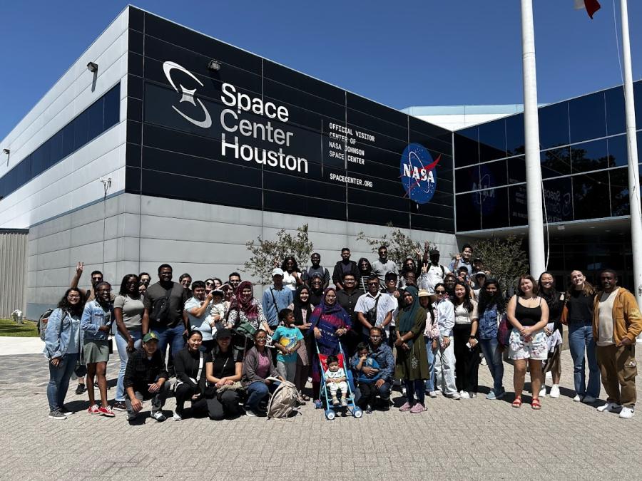 Group of students pose in front the Houston Space Center sign. 