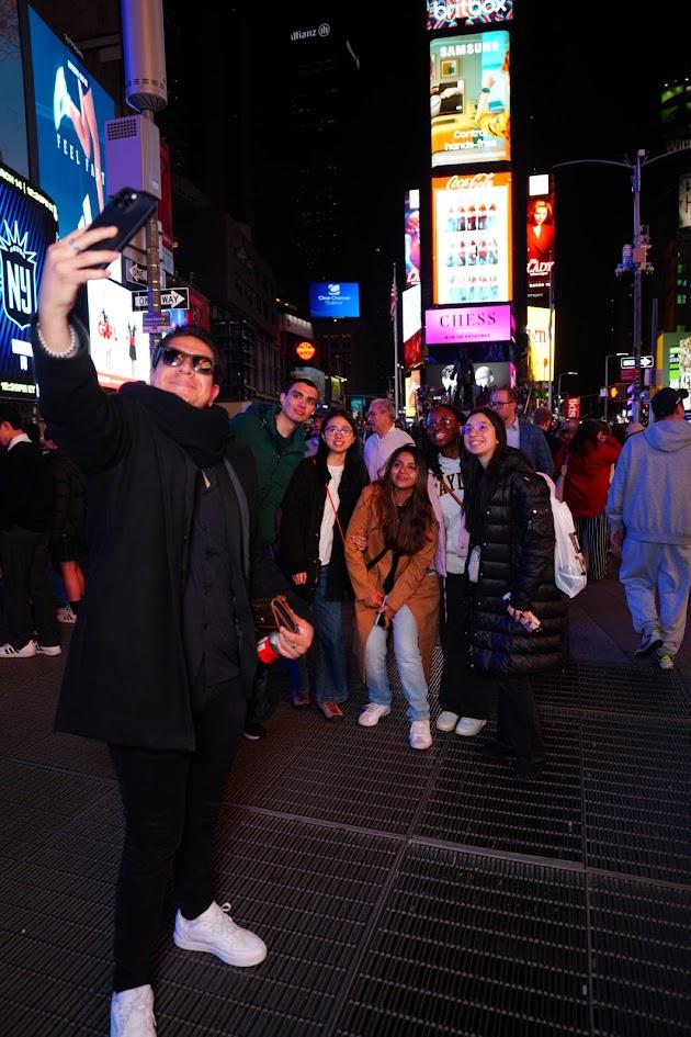 International students take a selfie in NYC's Times Square